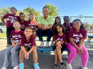 Abel Covarrubias with children from Boys & Girls Club outdoors