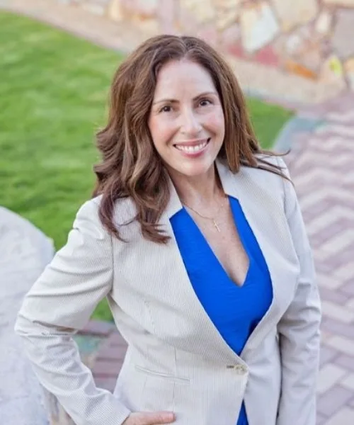 Monica Marrujo smiling in an outdoor professional portrait